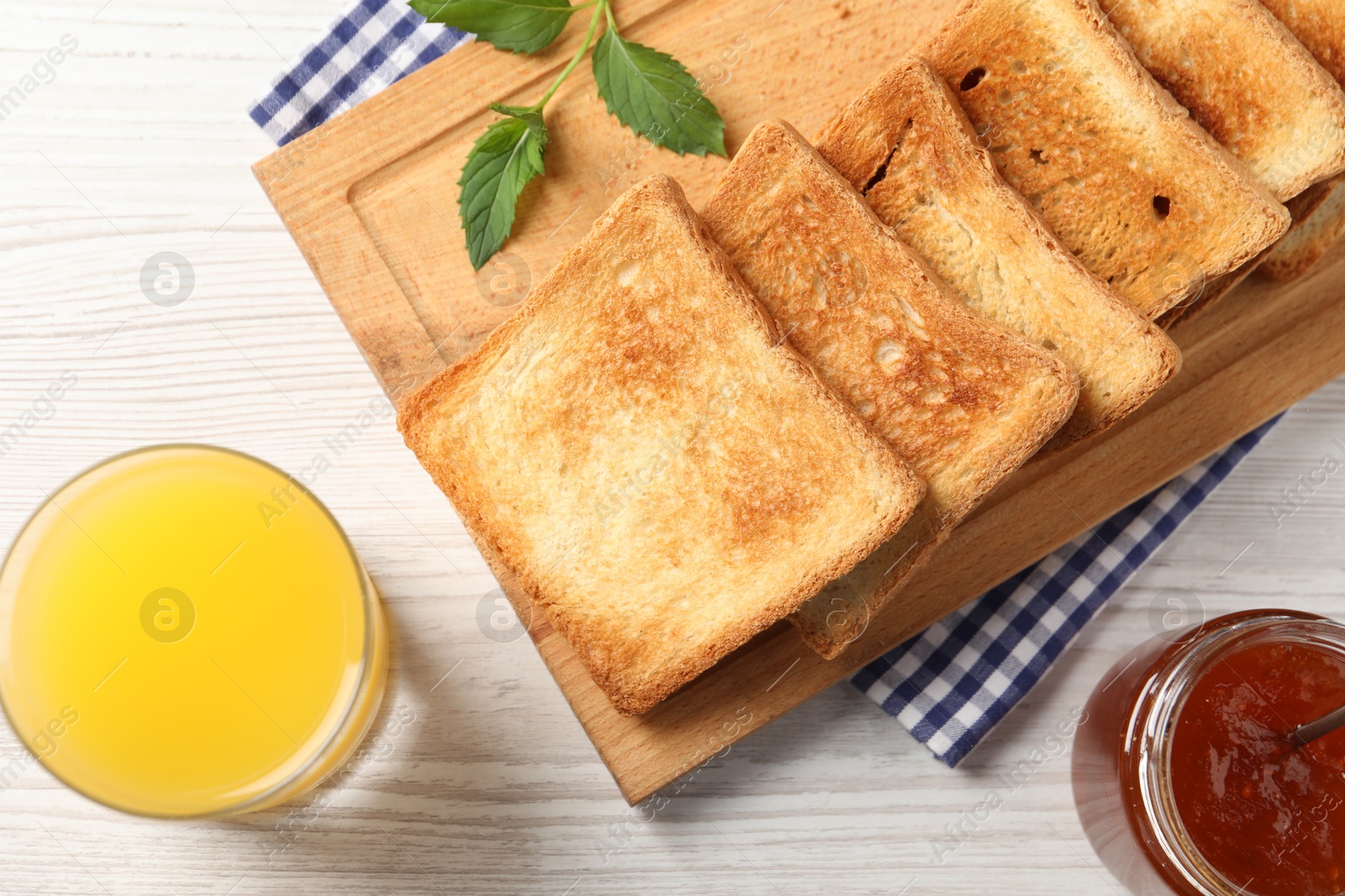 Photo of Delicious toasts served on wooden table, flat lay