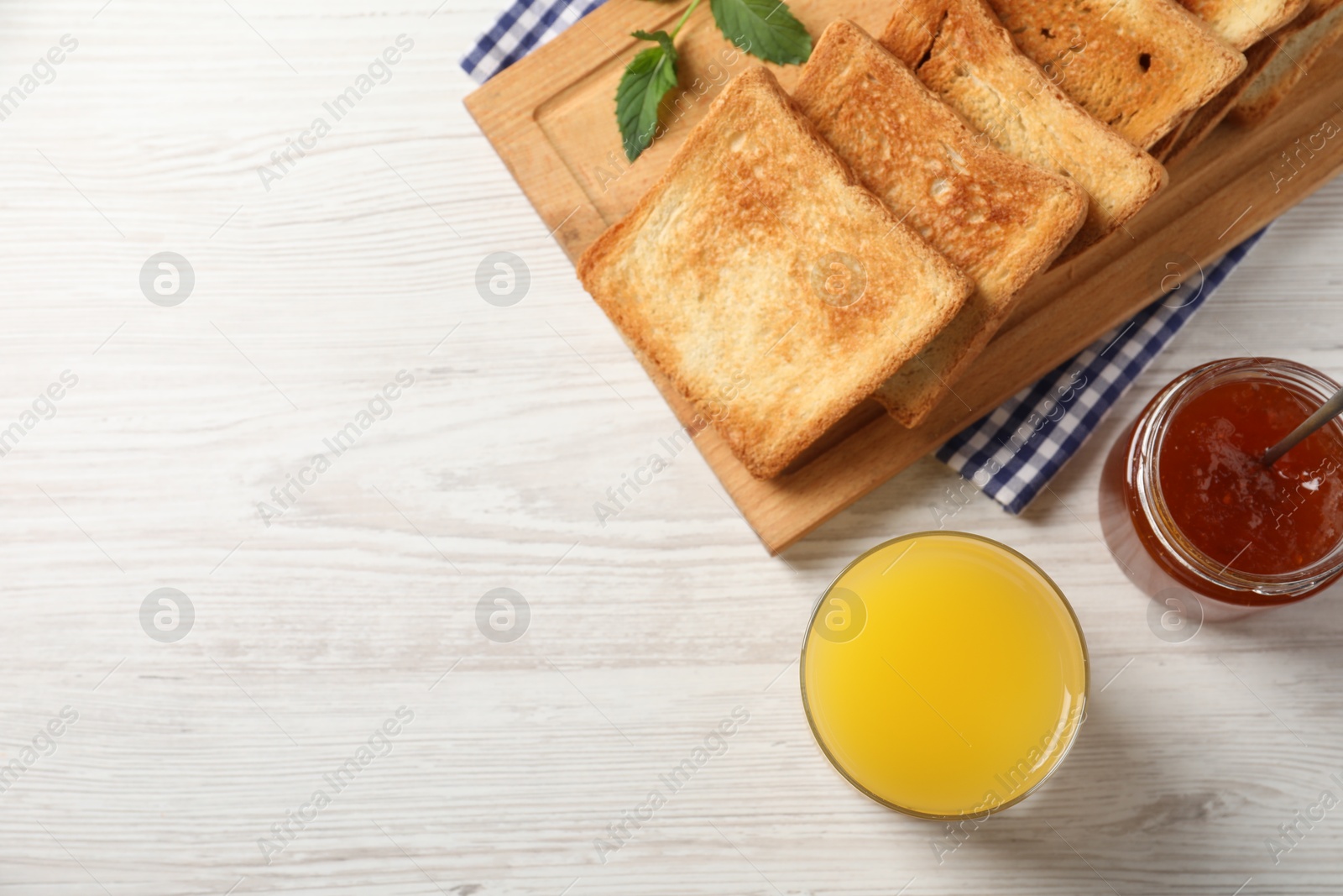 Photo of Delicious toasts served on wooden table, flat lay. Space for text