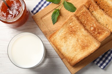 Photo of Delicious toasts served on wooden table, flat lay