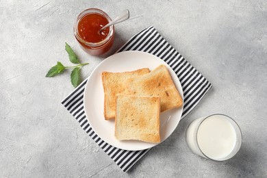 Photo of Delicious toasts served on light table, flat lay