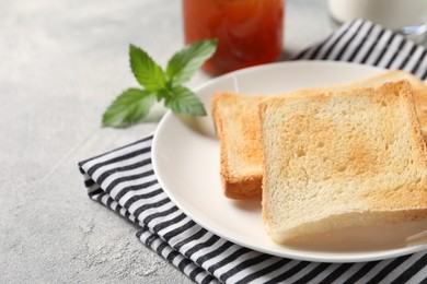 Photo of Delicious toasts served on light table, closeup