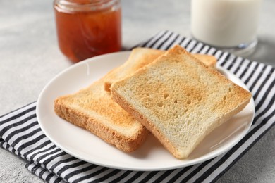 Photo of Delicious toasts served on light table, closeup