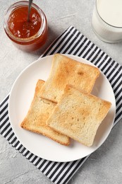 Delicious toasts served on light table, flat lay