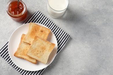 Photo of Delicious toasts served on light table, flat lay. Space for text