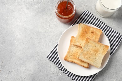 Delicious toasts served on light table, flat lay. Space for text