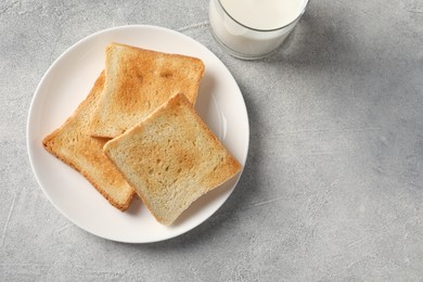 Delicious toasts with milk on light table, top view. Space for text