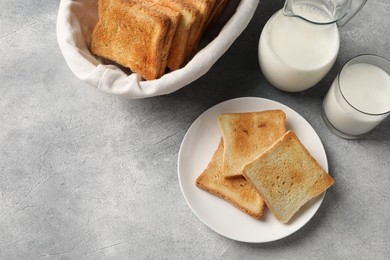 Photo of Delicious toasts served on light table, flat lay