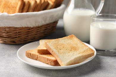 Photo of Delicious toasts served with milk on light table