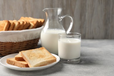 Delicious toasts served with milk on light table