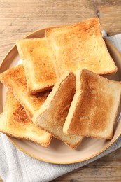 Photo of Delicious toasts on wooden table, top view