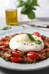 Photo of Fresh delicious burrata salad served on table, closeup