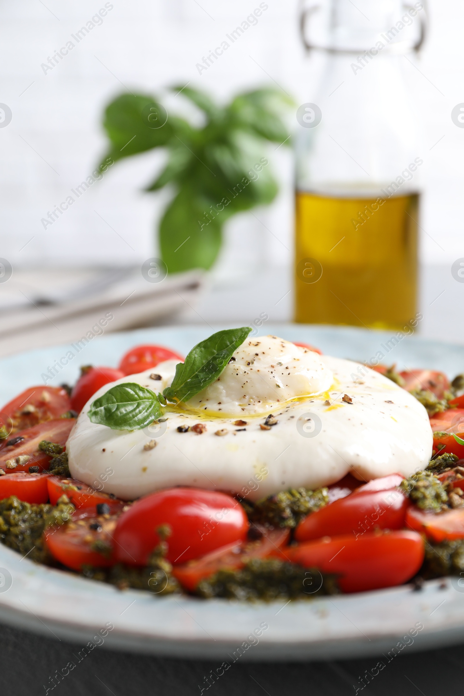 Photo of Fresh delicious burrata salad served on table, closeup