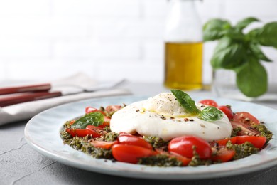 Fresh delicious burrata salad on light grey table, closeup