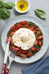 Photo of Fresh delicious burrata salad served on light grey table, top view