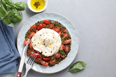 Fresh delicious burrata salad served on light grey table, top view. Space for text