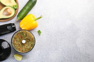 Photo of Hand blender kit, mixture of ingredients and fresh products on light grey table, flat lay. Space for text