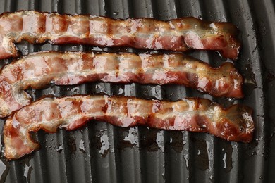 Photo of Slices of bacon on grill, top view