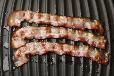 Photo of Slices of bacon on grill, top view