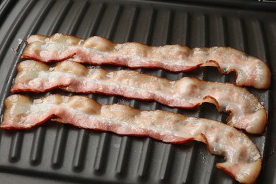 Photo of Slices of bacon on grill, closeup view