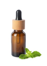 Photo of Bottle of essential oil and mint isolated on white