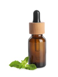 Photo of Bottle of essential oil and mint isolated on white