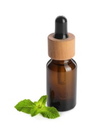 Photo of Bottle of essential oil and mint isolated on white