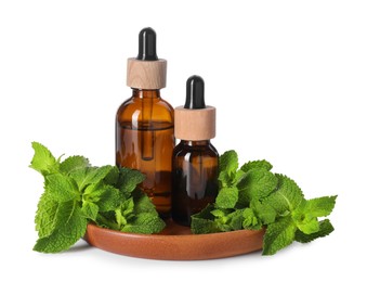 Photo of Bottles of essential oils and mint isolated on white