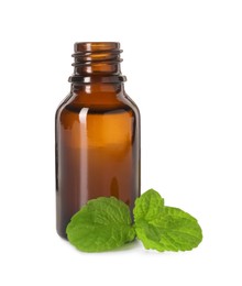 Photo of Bottle of essential oil and mint isolated on white