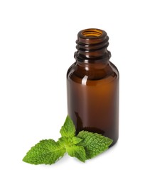 Photo of Bottle of essential oil and mint isolated on white