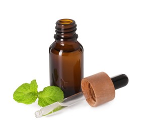 Photo of Bottle of essential oil, dropper and mint isolated on white