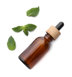 Photo of Bottle of essential oil and mint isolated on white, top view