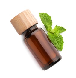 Photo of Bottle of essential oil and mint isolated on white, top view