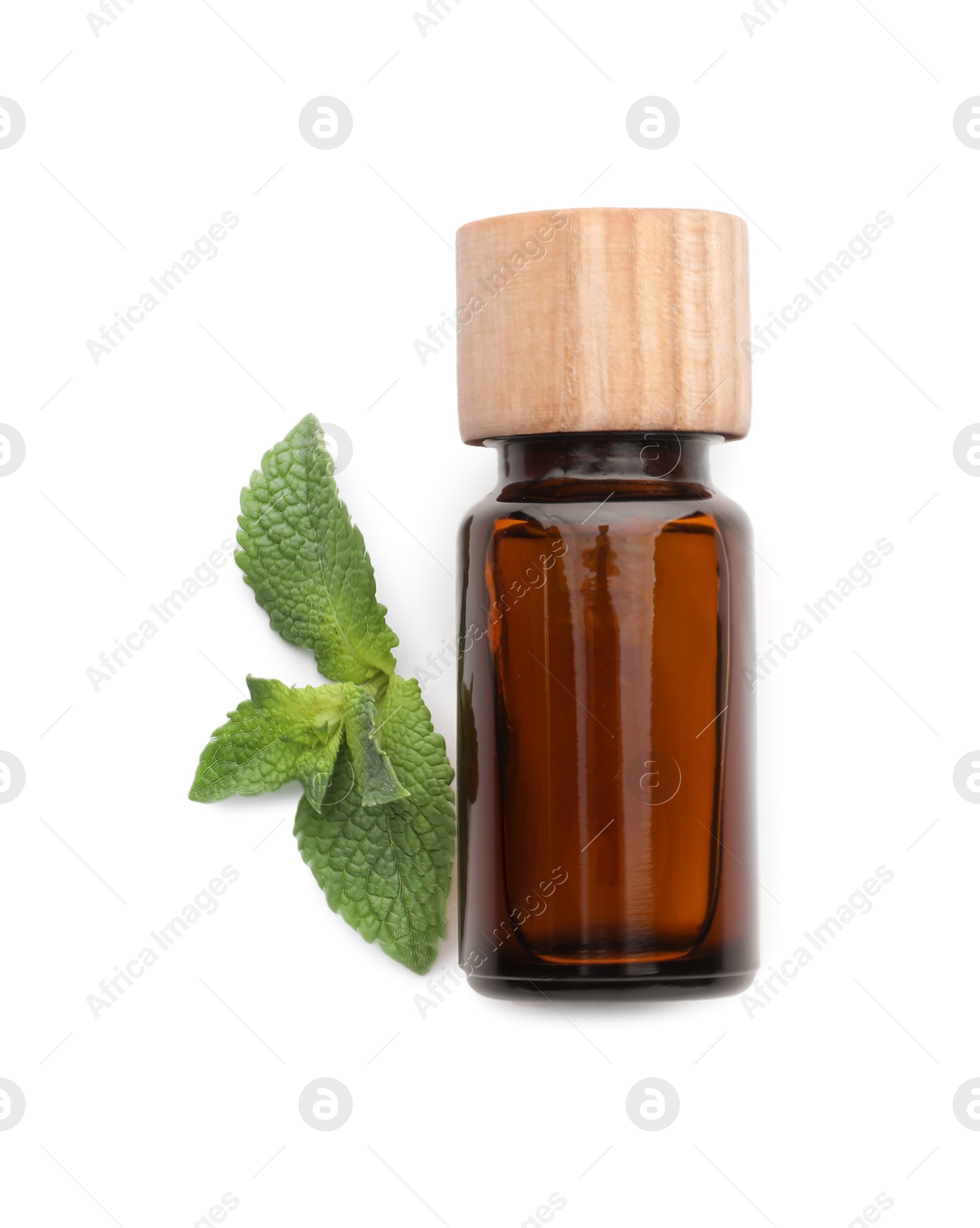 Photo of Bottle of essential oil and mint isolated on white, top view