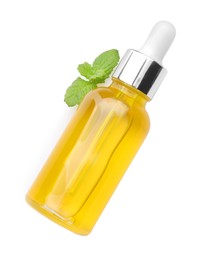 Photo of Bottle of essential oil and mint isolated on white, top view