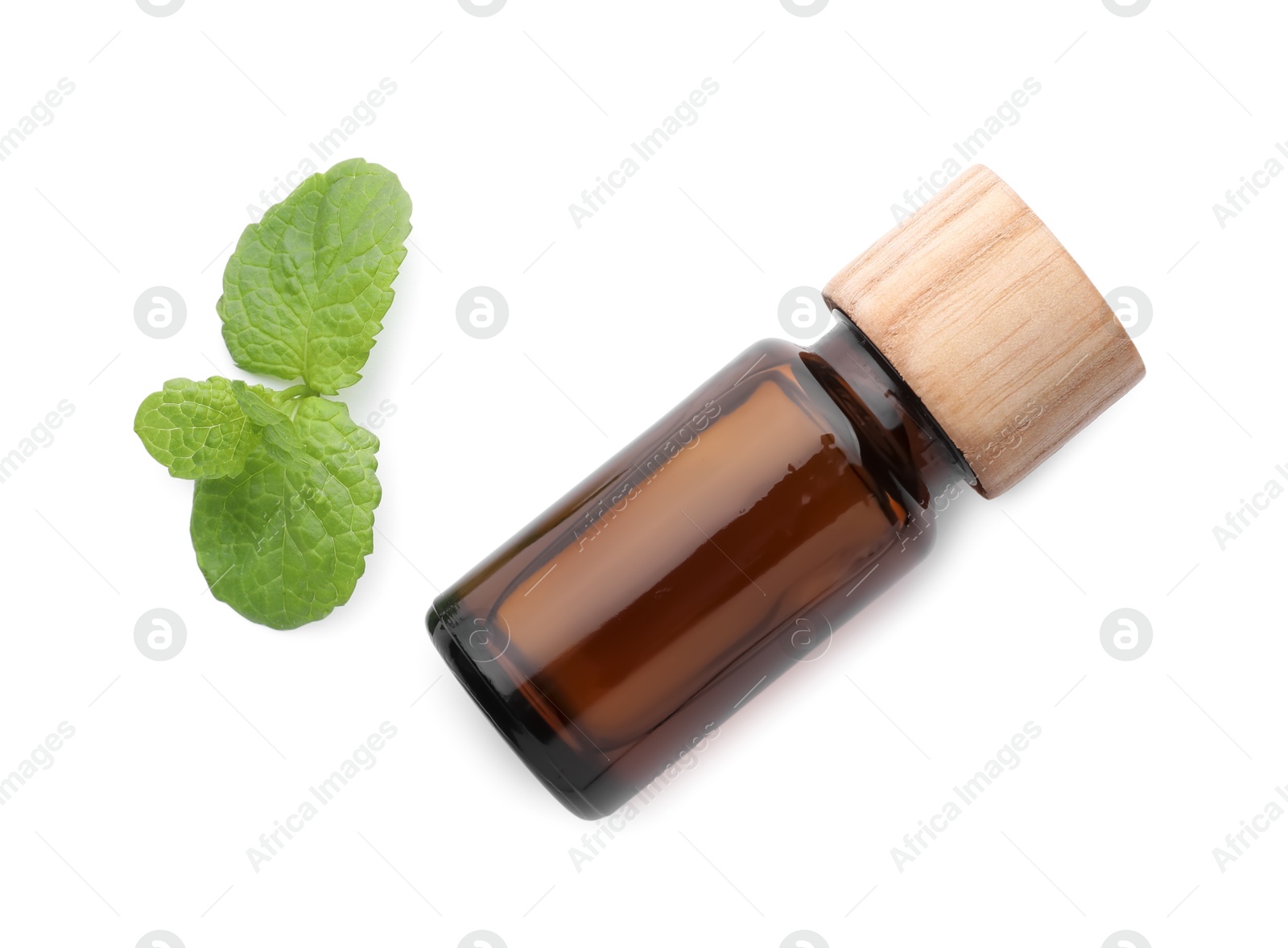 Photo of Bottle of essential oil and mint isolated on white, top view