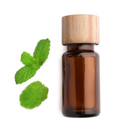 Photo of Bottle of essential oil and mint isolated on white, top view