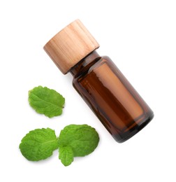 Photo of Bottle of essential oil and mint isolated on white, top view