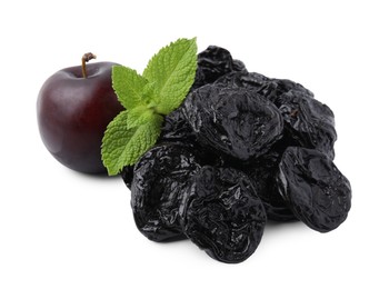 Delicious prunes, fresh ripe plums and mint isolated on white