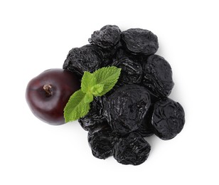 Delicious prunes, fresh ripe plums and mint isolated on white, top view