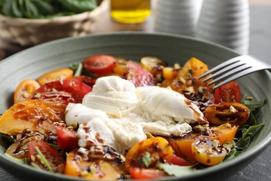 Fresh delicious burrata salad on table, closeup