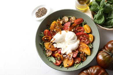 Photo of Fresh delicious burrata salad served on white table, top view