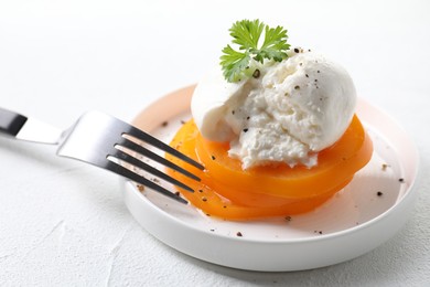 Photo of Delicious burrata cheese, tomato, parsley and fork on white table, closeup