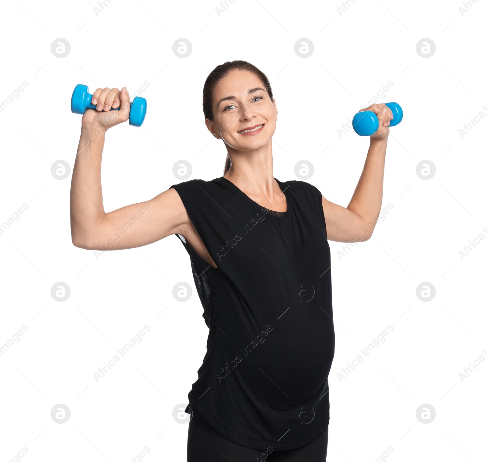 Photo of Beautiful pregnant woman with dumbbells doing exercises on white background