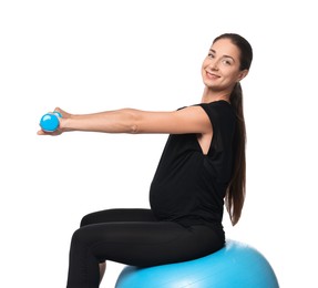 Photo of Beautiful pregnant woman with dumbbells doing exercises on fitball against white background