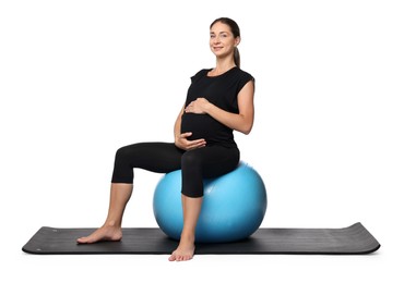 Photo of Beautiful pregnant woman doing exercises on fitball against white background