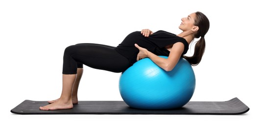 Beautiful pregnant woman doing exercises on fitball against white background