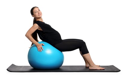 Beautiful pregnant woman doing exercises on fitball against white background