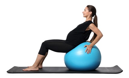 Photo of Beautiful pregnant woman doing exercises on fitball against white background