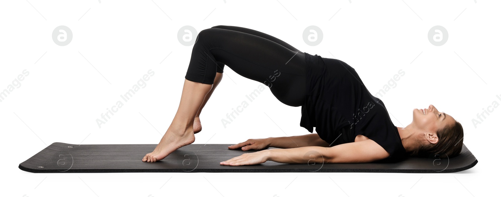 Photo of Beautiful pregnant woman doing stretching exercises on mat against white background