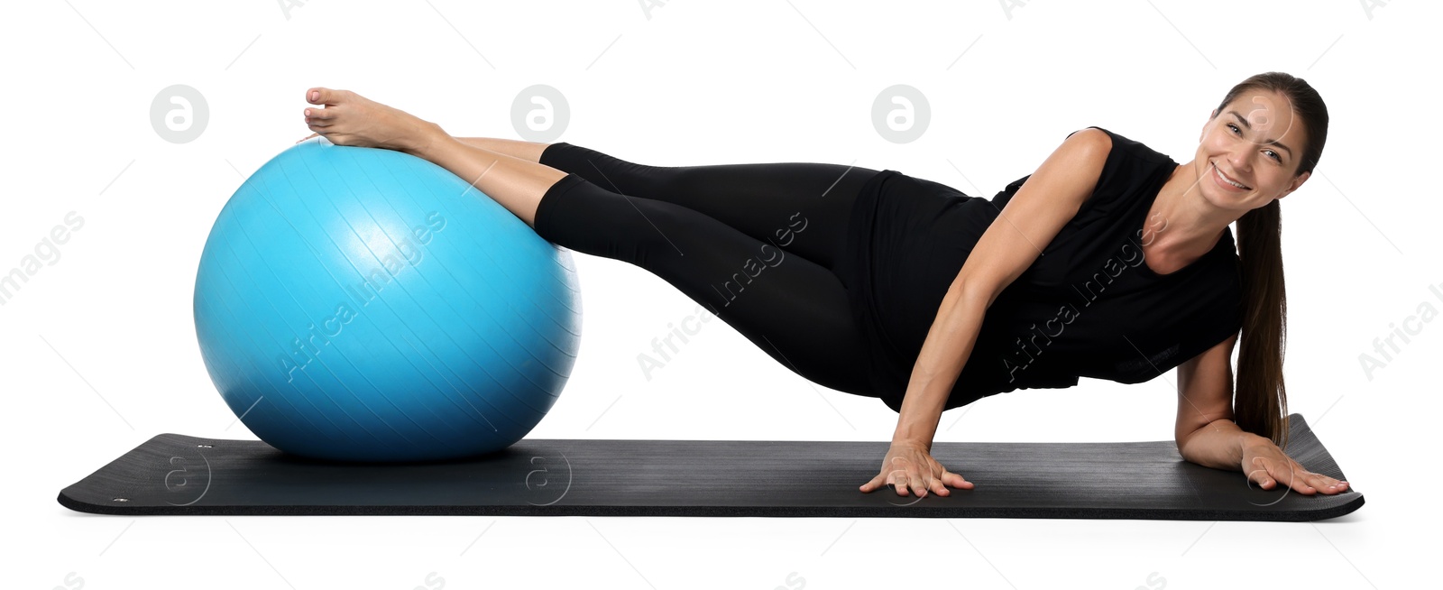 Photo of Beautiful pregnant woman with fitball doing exercises on mat against white background